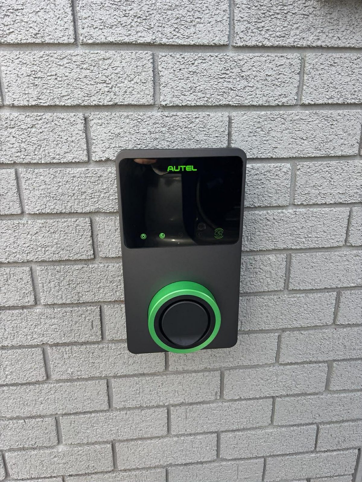 Autel EV charger installed on brick wall in Newcastle