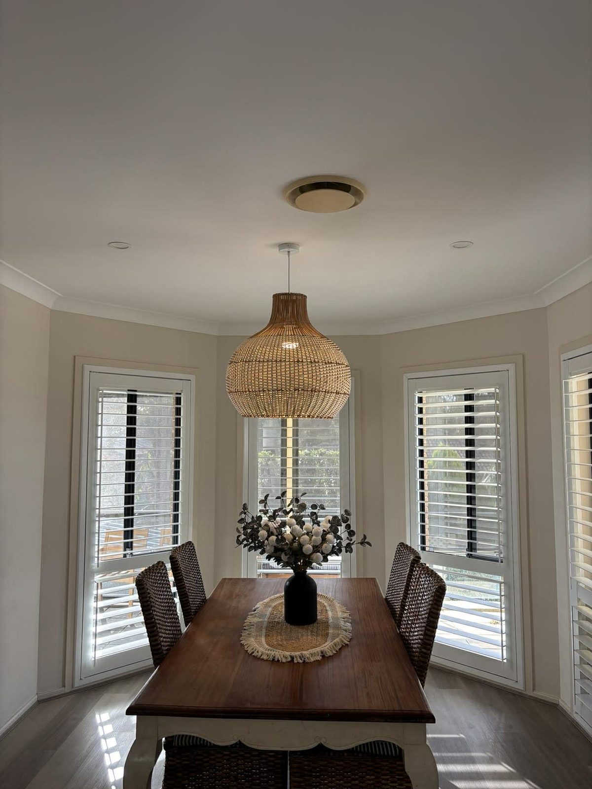 Rattan pendant light installed in a Newcastle dining room