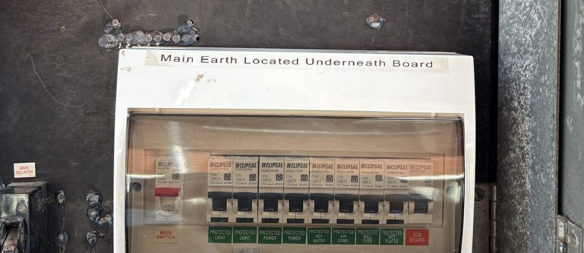 Switchboard with Clipsal RCBO safety switches and green PROTECTED labels for each circuit, installed by Nate's Rates